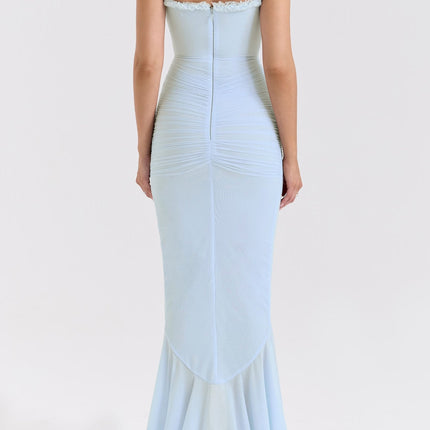 A long blue maxi dress with ruffle details and draped fabric featuring a flowy silhouette and feminine design