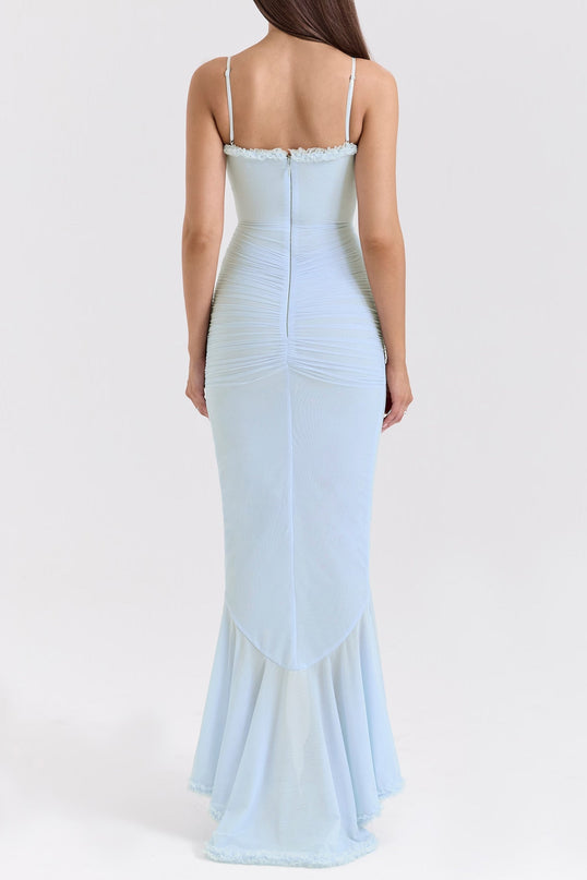 A long blue maxi dress with ruffle details and draped fabric featuring a flowy silhouette and feminine design