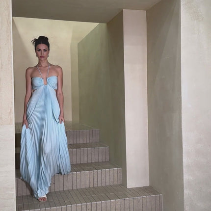 A long blue pleated maxi dress with a cutout detail named Andrea