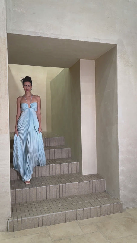 A long blue pleated maxi dress with a cutout detail named Andrea