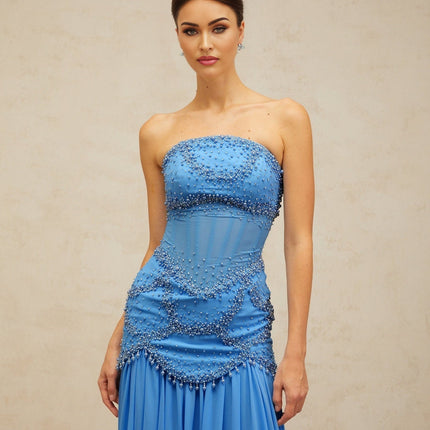 A long blue pleated maxi dress with faux pearl embellishments by Gaelle