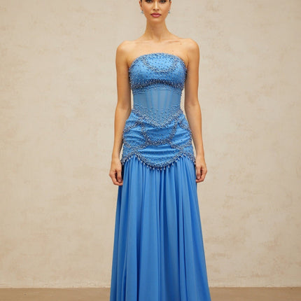 A long blue pleated maxi dress with faux pearl embellishments by Gaelle