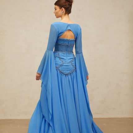 A long blue pleated maxi dress with faux pearl embellishments by Gaelle