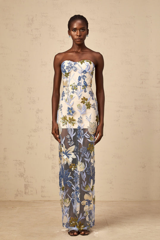 A long blue tulle maxi dress with a corset bodice featuring sequined flower embroidery and a flowy skirt