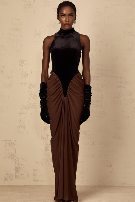 A long brown dress with velvet panels and ruched detailing named Mathilde