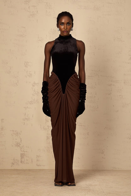 A long brown dress with velvet panels and ruched detailing named Mathilde