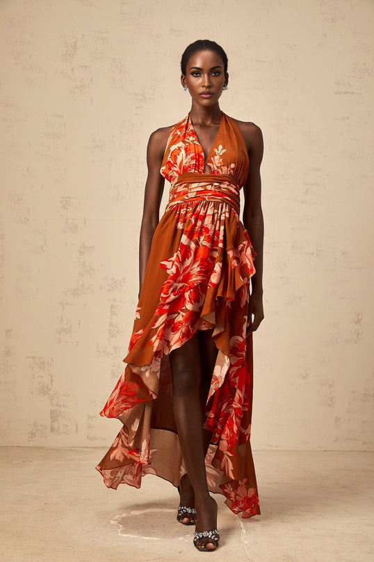 A long brown maxi dress with an asymmetrical hem featuring a floral print pattern and named Angelique