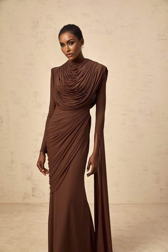 A long brown maxi dress with shirred detailing and draped fabric featuring a flowing silhouette and elegant design