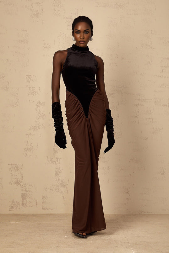 A long brown maxi dress with velvet panels and ruched detailing named Mathilde