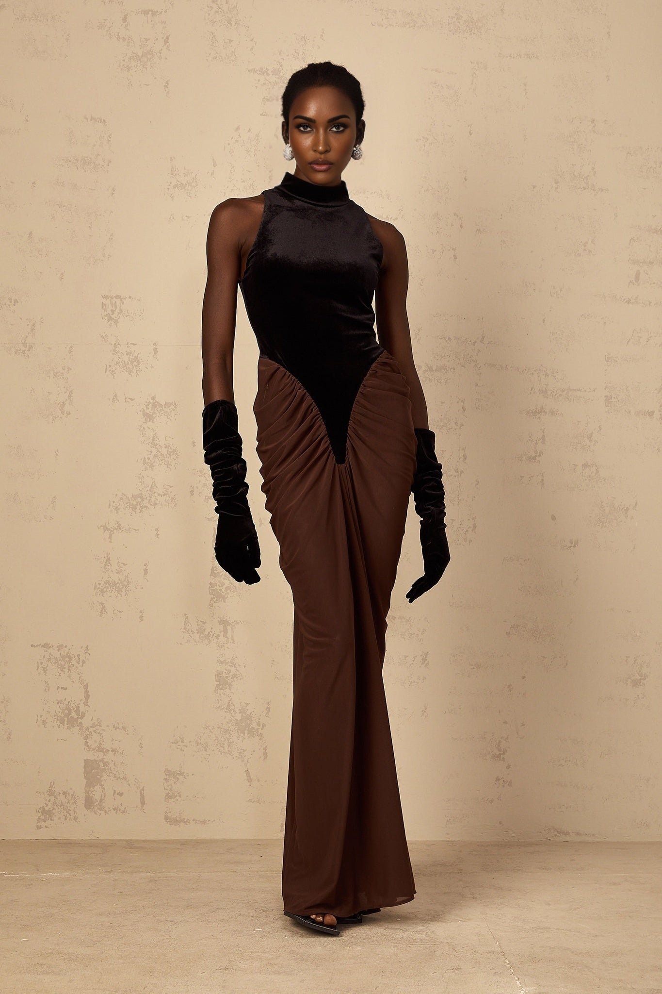 A long brown maxi dress with velvet panels and ruched detailing named Mathilde