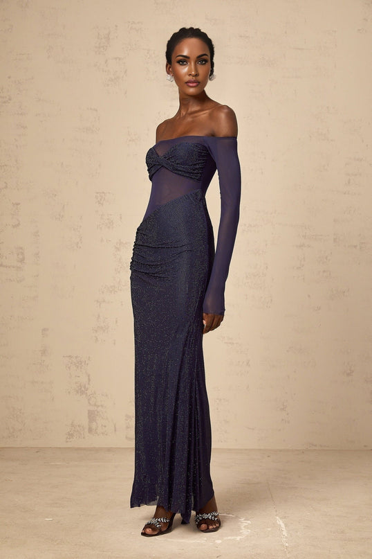 A long dark blue maxi dress with a corsetstyle bodice featuring embellishments and sheer tulle panels