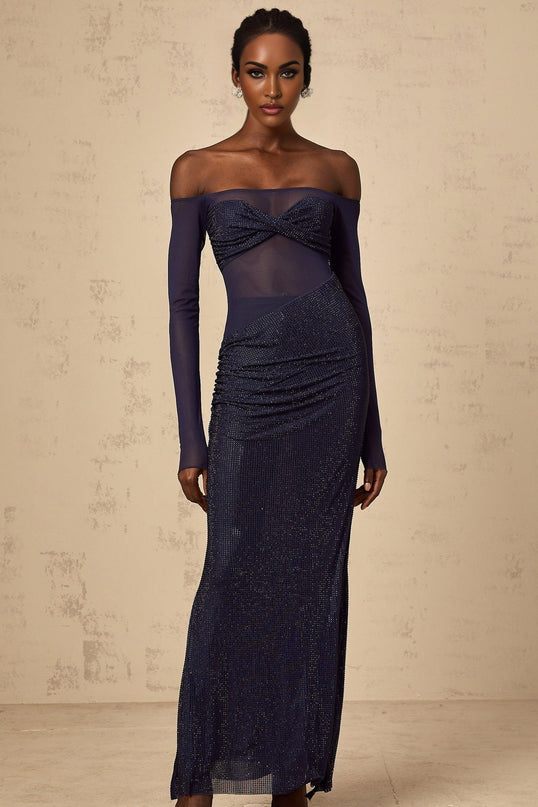 A long dark blue maxi dress with a corsetstyle bodice featuring embellishments and tulle panels