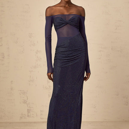 A long dark blue maxi dress with a corsetstyle bodice featuring sheer tulle panels and embellished details