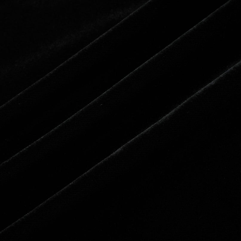 A long dark velvet dress with an open back and embellishments named Audrey shown on a model against a plain background