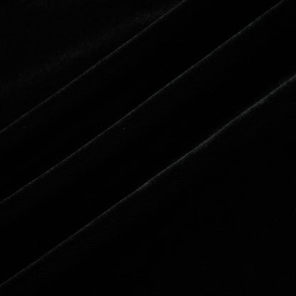 A long dark velvet dress with an open back and embellishments named Audrey shown on a model against a plain background
