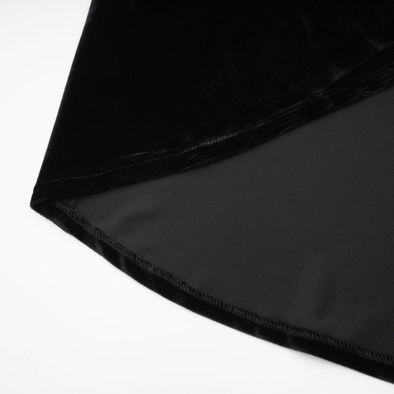 A long dark velvet dress with an open back and embellishments named Audrey shown on a model