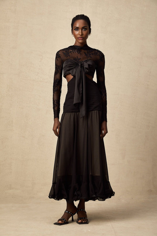 A long elegant maxi dress featuring floral lace panels and a flowing silhouette with a feminine design by Maiwenn