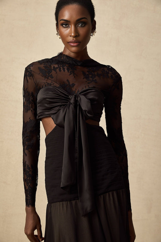 A long elegant maxi dress with floral lace panels and a flowing silhouette in a feminine design by Maiwenn