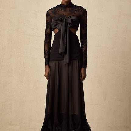 A long elegant maxi dress with floral lace panels featuring a delicate pattern throughout the garment The dress has a flowing silhouette and appears to be made of lightweight fabric suitable for formal or evening wear