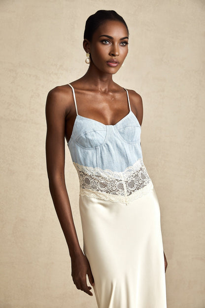 A long elegant maxi dress with lace trim and paneled design featuring a flowy silhouette in a soft fabric