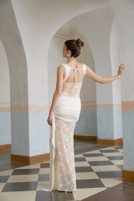 A long floral lace maxi dress in neutral tones featuring ribbon panelling and a delicate design