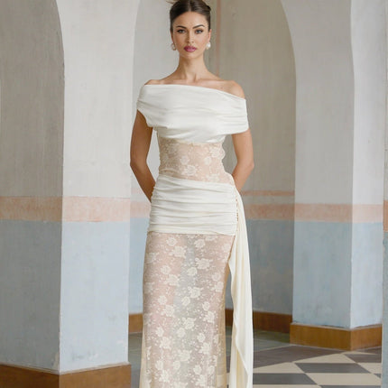 A long floral lace maxi dress in neutral tones with ribbon paneling and a flowing silhouette