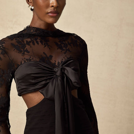 A long floral lace maxi dress with panelled design featuring a mix of sheer and opaque sections in a romantic and feminine style