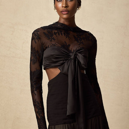 A long floral lace maxi dress with panels featuring intricate lace patterns and a flowing silhouette in a romantic style