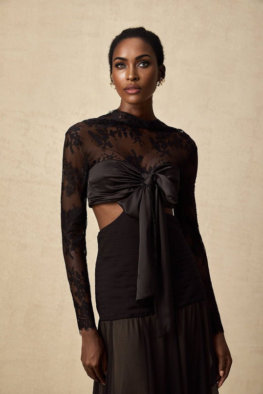 A long floral lace maxi dress with panels featuring intricate lace patterns and a flowing silhouette in a romantic style