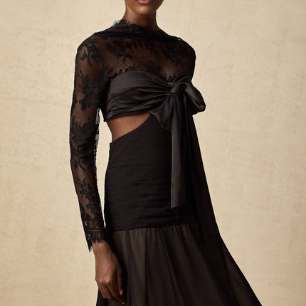 A long floral lace maxi dress with sheer panels featuring a delicate floral pattern throughout the bodice and skirt creating an elegant and romantic silhouette