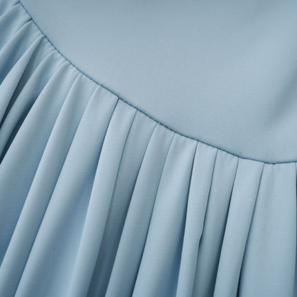A long flowing baby blue dress with an asymmetric neckline and pleated skirt reaching to the floor
