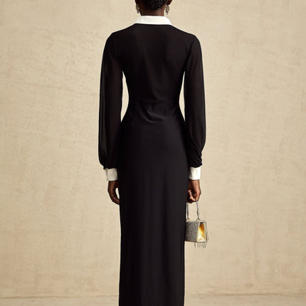 A long flowing maxi dress with contrasting colors and semisheer fabric featuring a delicate and feminine design