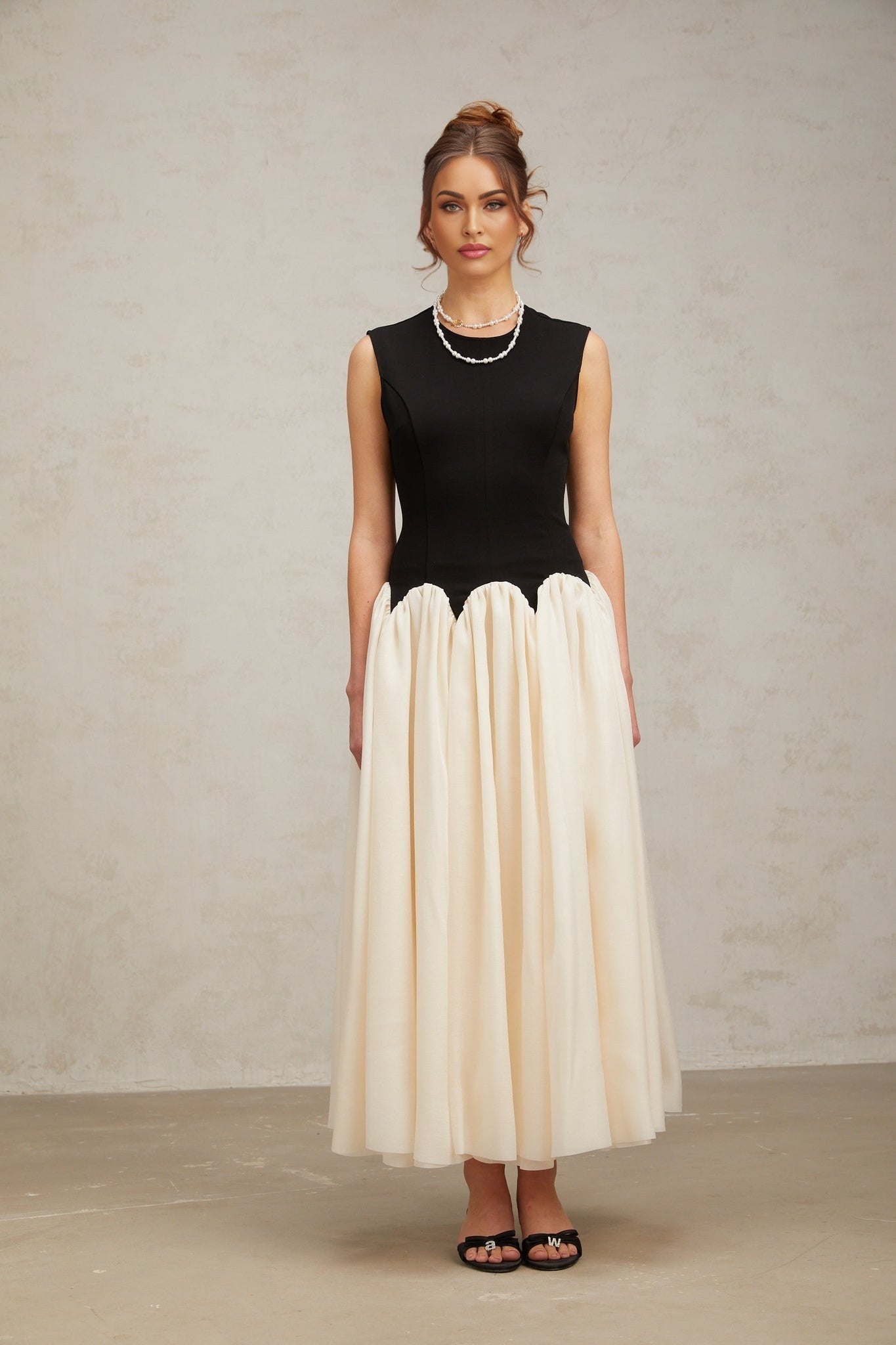 A long flowing maxi dress with puffed sleeves featuring colorblocked sections in contrasting hues named Josette