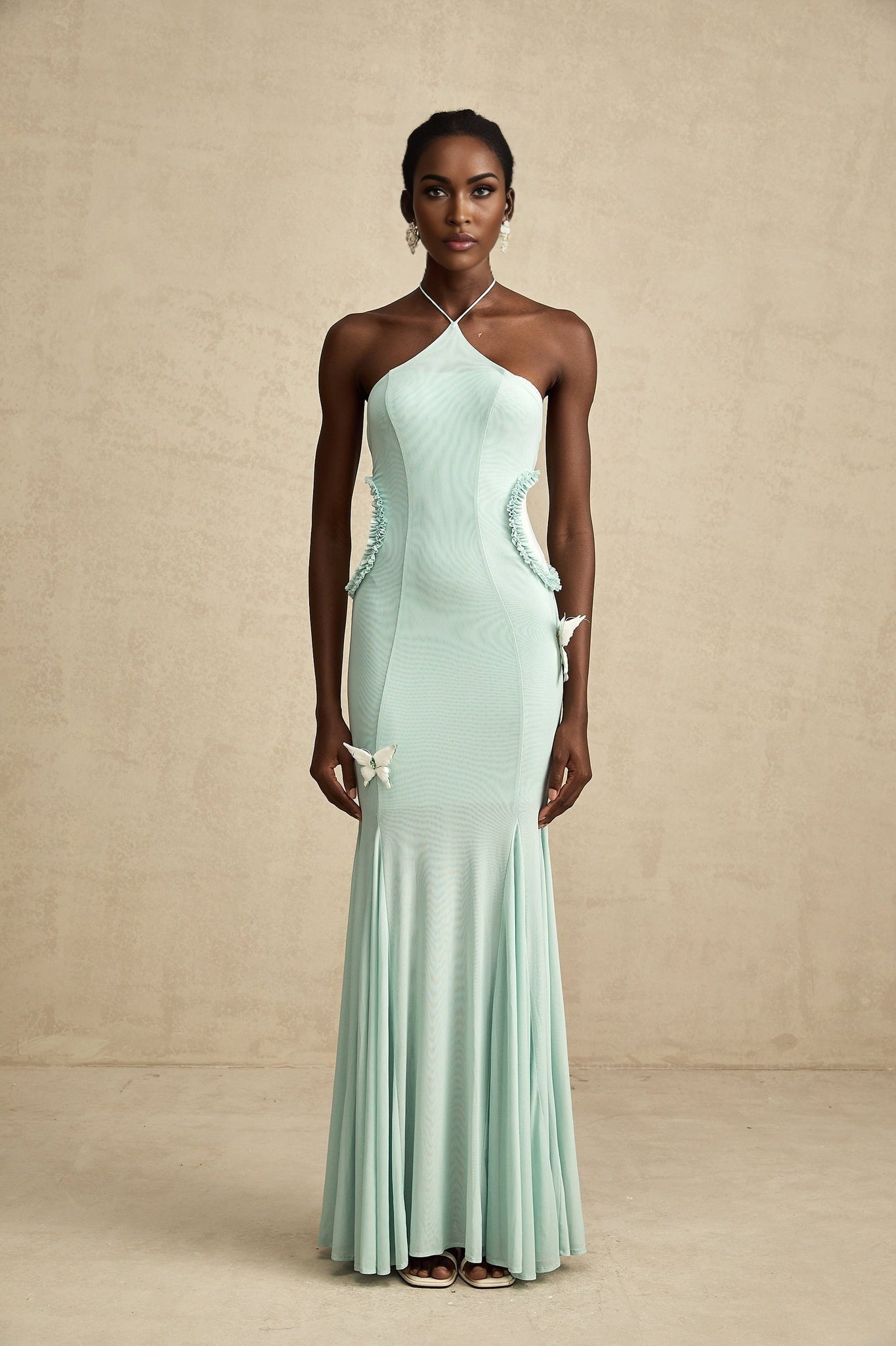 A long flowing maxi dress with ruffle details and a butterfly pattern named Amelie