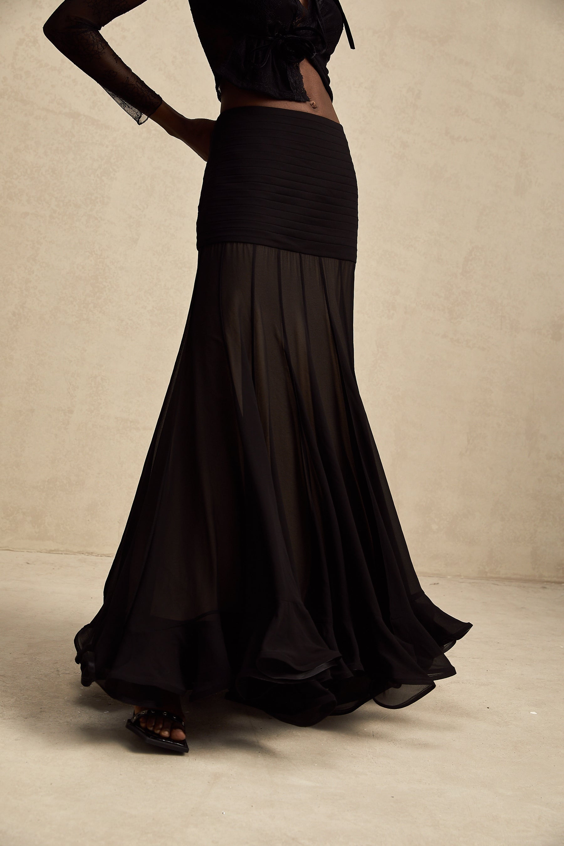A long flowing maxi skirt with ruffles and pleats made of rayon and tulle fabric in a Jacqueline style