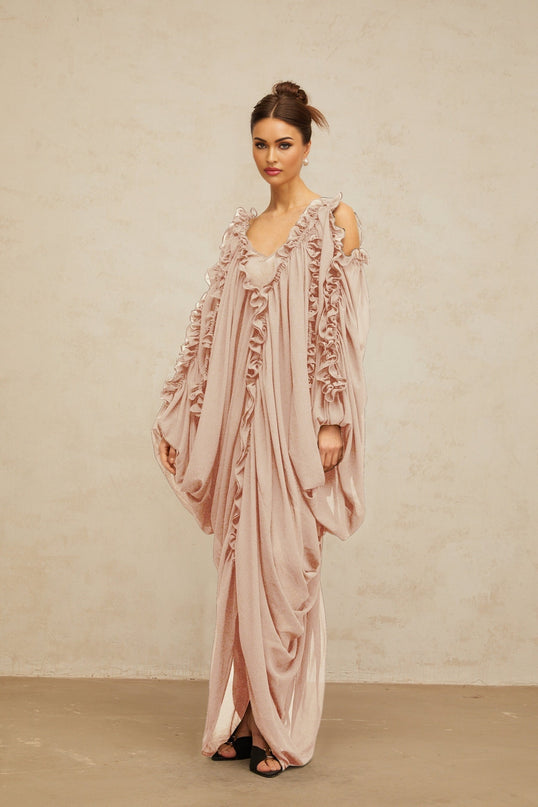A long flowing tulle maxi dress with ruffled trim details and a feminine silhouette