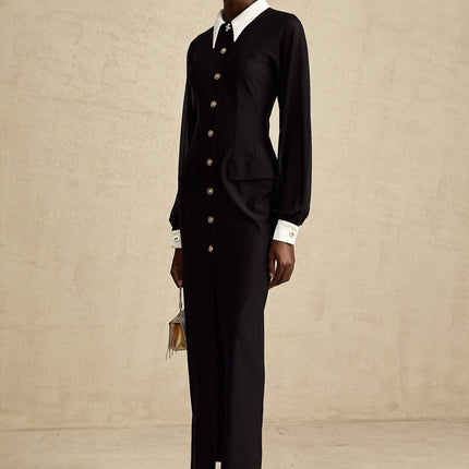 A long flowy maxi dress with contrasting colors and semisheer fabric featuring a feminine silhouette