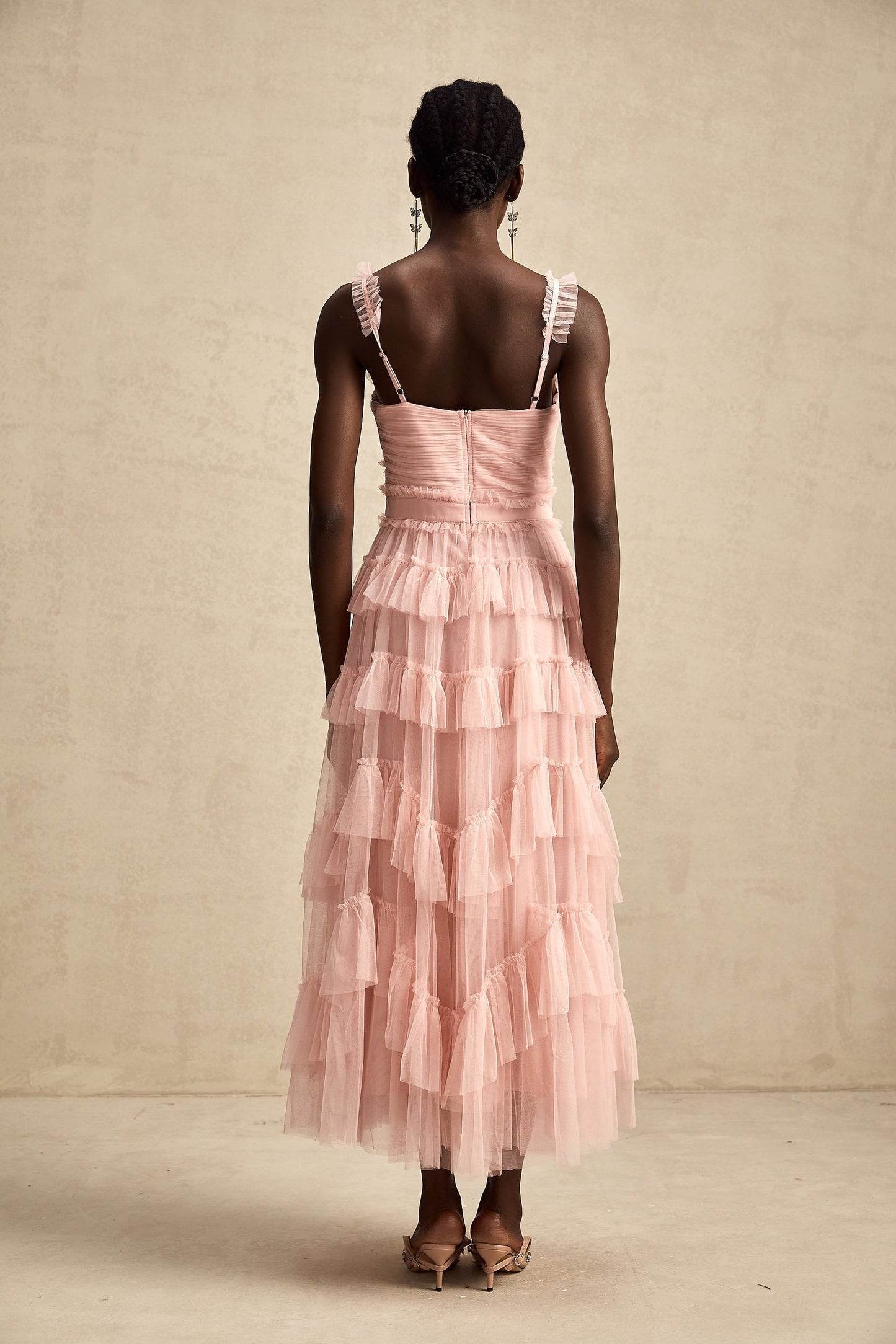 A long flowy maxi dress with multiple layers of ruffled tulle fabric creating a romantic and ethereal look