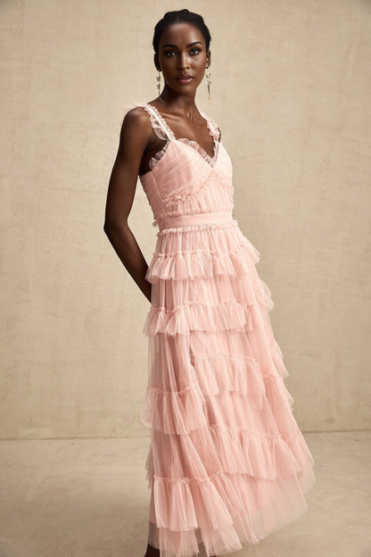 A long flowy maxi dress with multiple layers of ruffled tulle fabric creating a romantic and ethereal silhouette
