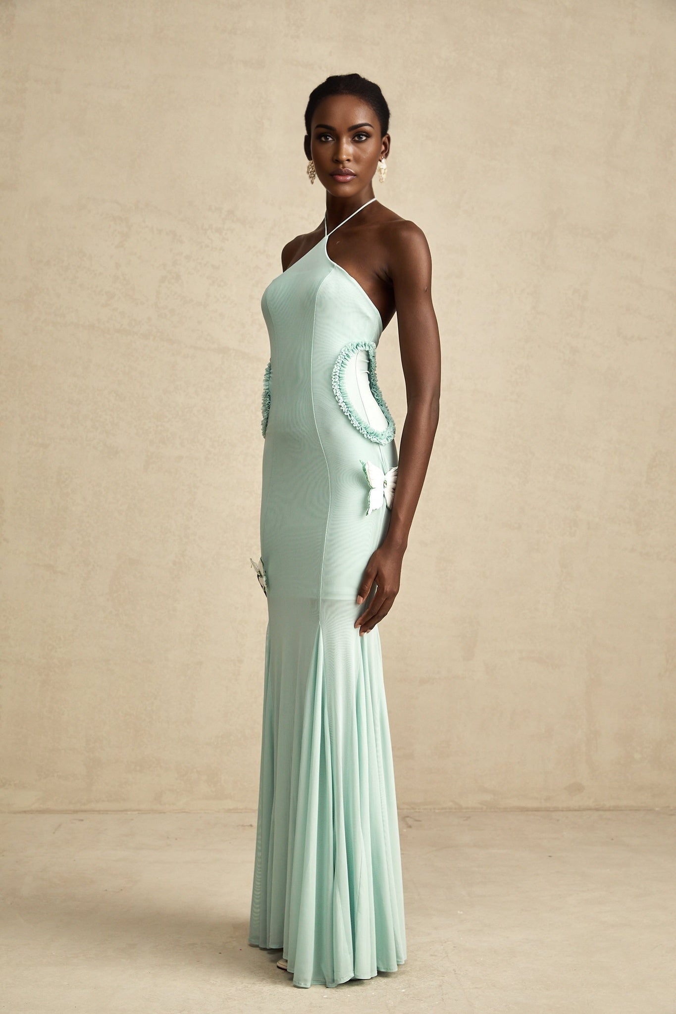 A long flowy maxi dress with ruffle details and a butterfly pattern named Amelie