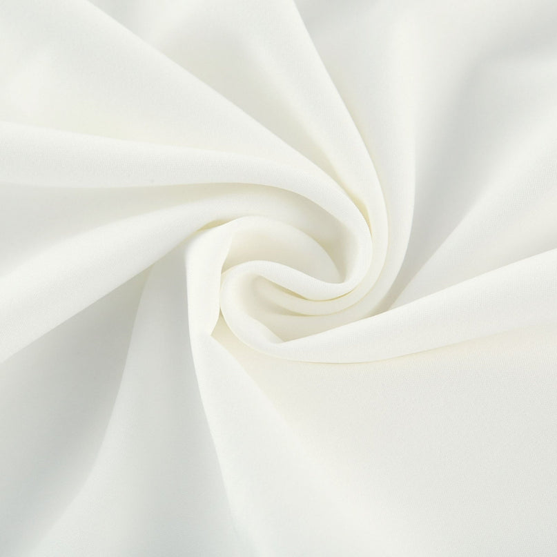 A long flowy pleated maxi dress in contrasting colors featuring a gathered waist and flowing skirt