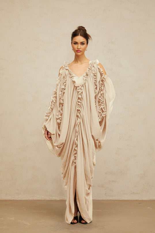 A long flowy tulle maxi dress with ruffled trim details and a feminine silhouette