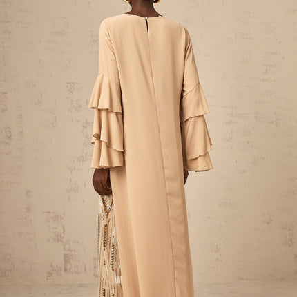 A long formal maxi dress with sequin embellishments ruffle sleeves and tulle fabric in a flowing silhouette