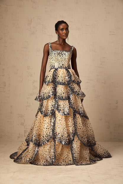 A long formal maxi dress with tiered layers of sequined petals cascading down the length creating a shimmering floral effect