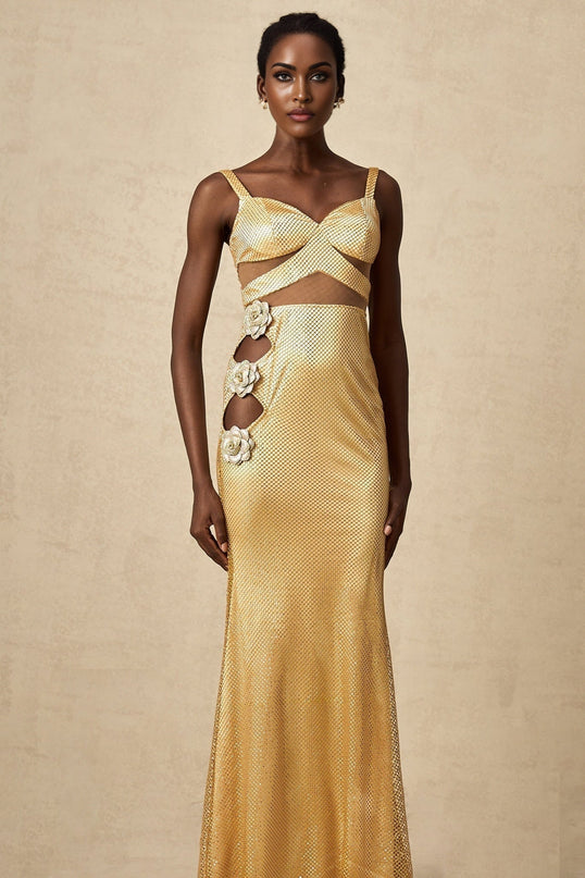 A long gold maxi dress with floral cutout designs and a flowing silhouette