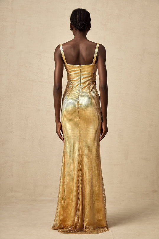 A long gold maxi dress with floral cutout details and a sleek silhouette called Giulia