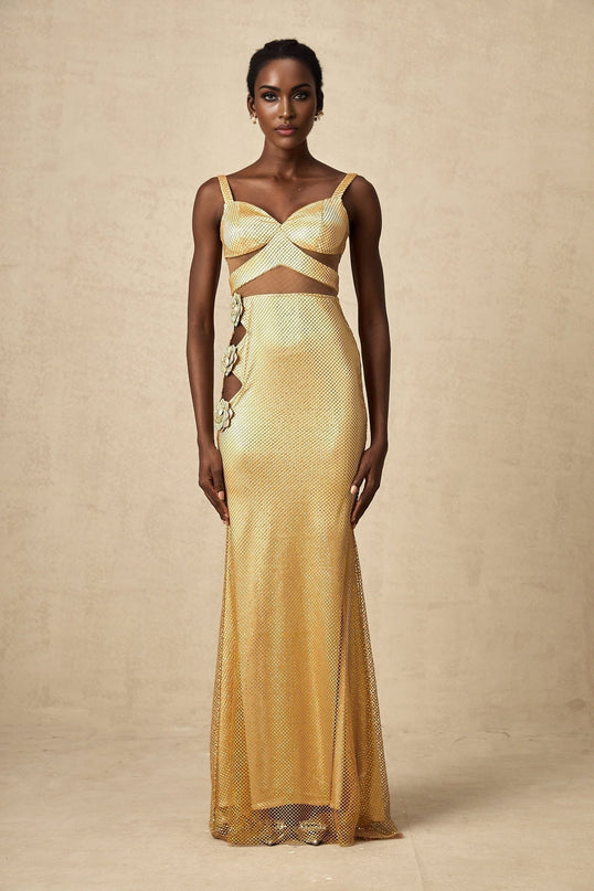 A long gold maxi dress with floral cutout patterns and a flowing silhouette named Giulia