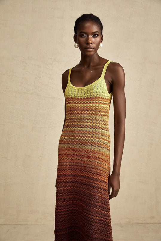 A long knitted maxi dress in gradient colors featuring an Audrey style silhouette