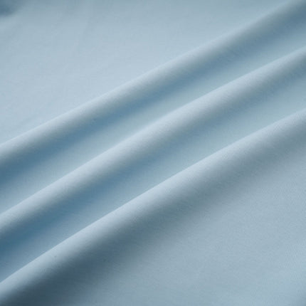 A long light blue asymmetric maxi dress with pleated details and a flowing silhouette