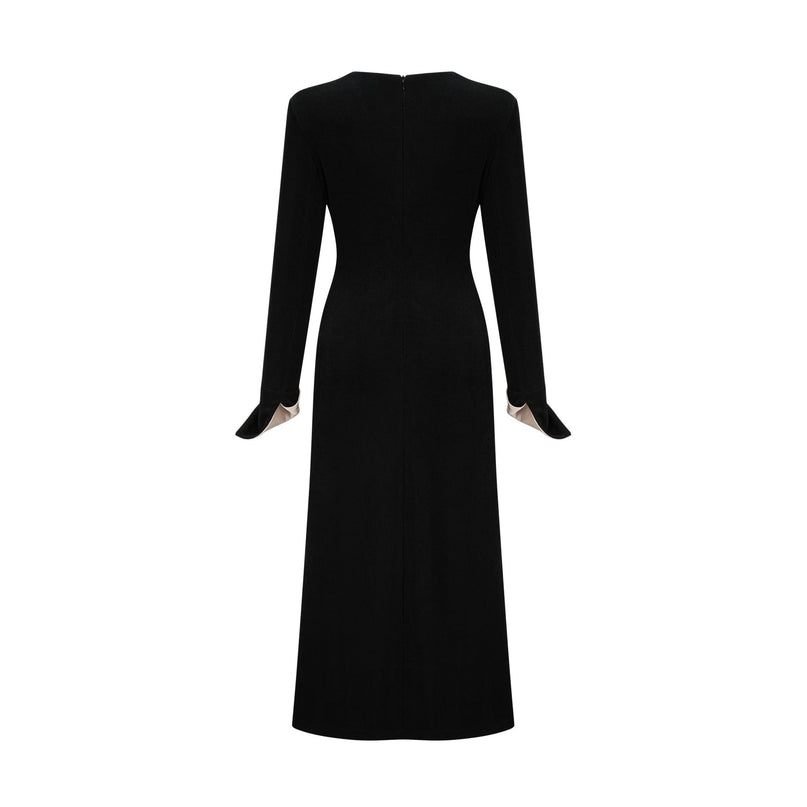 A long maxi dress with a vneck and contrasting colors featuring a bow detail at the neckline